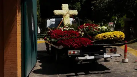 Reuters A truck transporting a flower‑covered cross enters the Recinto de la Paz cemetery, where, according to local media, the body of cartel leader Nemesio Oseguera Cervantes, known as “El Mencho,” who was killed on February 22 in a military operation in the state of Jalisco, was brought following his wake, in Zapopan, Mexico, March 2, 2026.