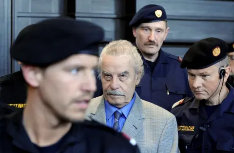 Reuters Josef Fritzl surrounded by police officers 
