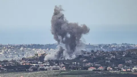 AFP via Getty Images Plumes of smoke rise from the site of an Israeli airstrike on the village of Zawtar al-Sharqiyah in southern Lebanon.