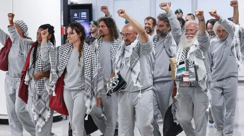 Getty Images Some of the flotilla activists arriving in Rome on Thursday
