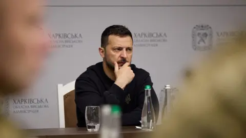 Reuters Ukraine's President Volodymyr Zelensky at a meeting with top military officials as he visits Kharkiv region, 16 May 2024