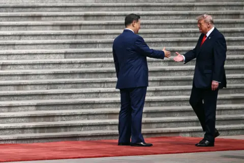 AFP via Getty Images US President Donald Trump (R) shakes hands with China's President Xi Jinping during a welcome ceremony at the Great Hall of the People in Beijing on May 14, 2026.