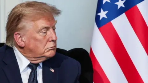 EPA Close up of US President Donald Trump and an American flag as he attends a bilateral meeting with French President Emmanuel Macron