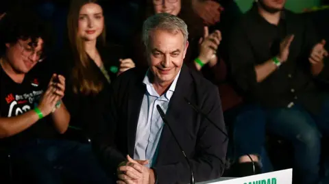 Getty Images Jose Luis Rodriguez Zapatero wears a suit at a microphone