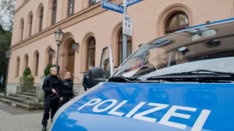 Getty Images A stock image taken outside of the court in Celle. Some police officers can be seen in the mid-distance, with the bonnet of a police van visible in the near ground, with the word 'Polizei' written on the bonnet
