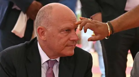 AFP via Getty Images Air India CEO Campbell Wilson is applied a ceremonial tika at an event in 2024. 