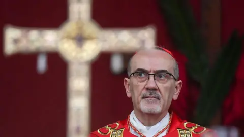 Getty Images Latin Patriarch of Jerusalem, Cardinal Pierbattista Pizzaballa, leads a prayer service to mark Palm Sunday in Jerusalem on March 29, 2026, following the cancellation of the traditional Palm Sunday procession from the Mount of Olives amid restrictions on gathering in large groups and the US-Israeli war on Iran