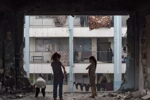 EPA children in destroyed school in Khan Younis after leaving Rafah