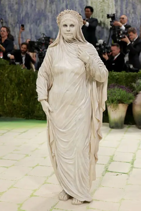 REUTERS/Daniel Cole Heidi Klum stands on the white stairs at the Met Gala dressed as a marble statue wearing a veil