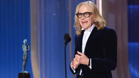 Getty Images Amy Madigan accepts the Outstanding Performance by a Female Actor in a Supporting Role Award for "Weapons" onstage during the 32nd Annual Actor Awards at Shrine Auditorium and Expo Hall on March 01, 2026 in Los Angeles, California.
