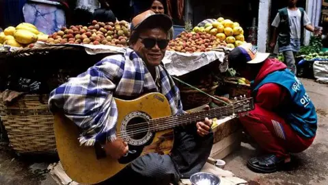 Getty Images Roadside Guitarist in Shillong , Meghalaya. (Photo by: Parvin Singh/ INDIAPICTURE/Universal Images Group via Getty Images)