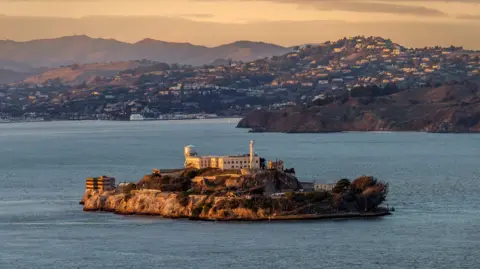 Getty Images A stock image of Alcatraz prison, showing a building sitting on an island 
