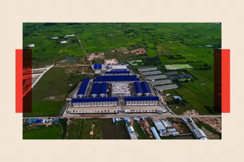 Reuters An aerial view showing a large compound made up of multiple buildings with blue roofs in the middle of an area with green fields