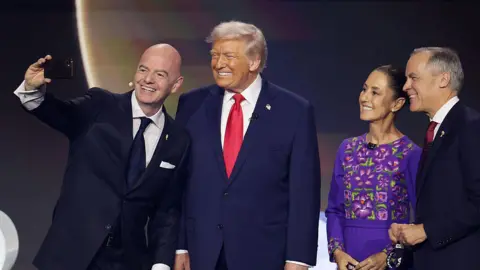 Getty Images Gianni Infantino takes a selfie with Donald Trump, Claudia Sheinbaum and Mark Carney