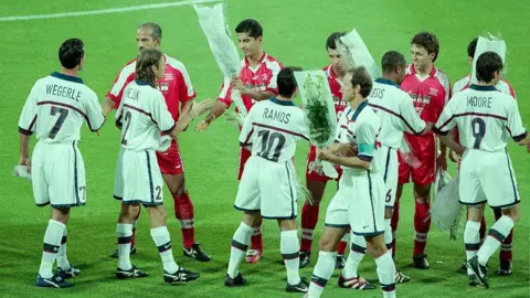 Getty Images L-R: Frankie Hejduk, Tab Ramos, Joe Max Moore, David Regis, Kasey Keller and Thomas Dooley of USA exchange flowers with the Iranian Team before the World Cup 1st round match between USA (1) and Iran (2) at the Stade de Garland on June 21, 1998 in Lyon, France. 