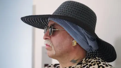 Alamy Marla-Svenja Liebich wears a blue hat and dark glasses - with a tattoo on her neck