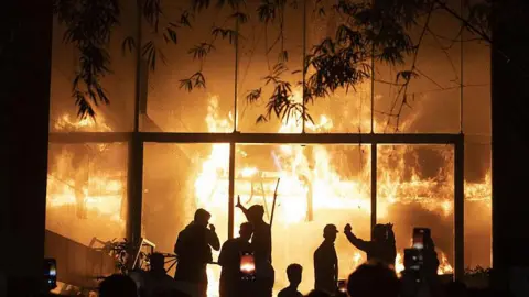 Anadolu via Getty Images The multi-storey building of Bangladesh newspaper Daily Star in flames after being atacked by a mob