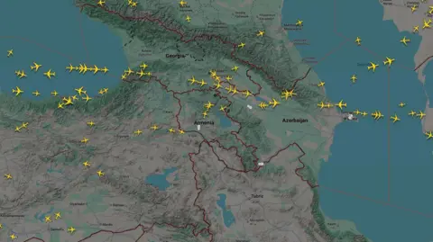 Flightradar24 Map of Azerbaijan and surrounding countries taken from Flightradar24's website, showing in yellow the planes flying over in real time. The are scattered about in some areas, none are flying over northern Iran and none over southern Azerbaijan. There is a cluster over northern Azerbaijan.