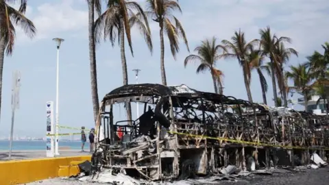 EPA Burned out vehicles on the boardwalk in Puerto Vallarta, Mexico