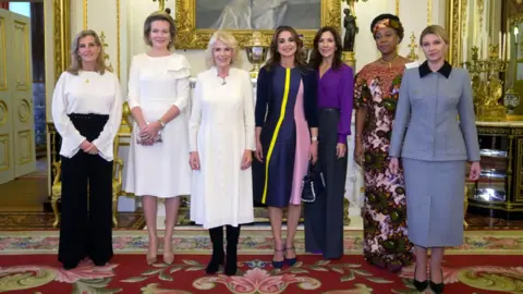 AFP via Getty Images Seven women pose for a group photograph in an ornate room with gold-framed artwork. They are: Britain's Sophie, Duchess of Edinburgh, Queen Mathilde of Belgium, Britain's Queen Camilla, Queen Rania of Jordan, Crown Princess Mary of Denmark, Fatima Bio, and the first lady of Ukraine Olena Zelenska. 
