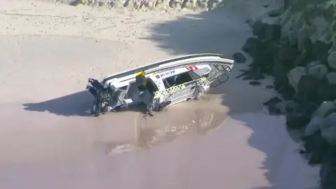 Australian Broadcasting Corporation A rescue boat on its side on the shoreline