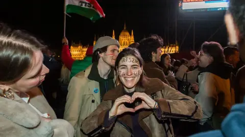 AFP via Getty Images Young people celebrate in the dark