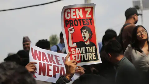 Getty Images Signs saying "Gen Z Protests, Save the Future" and "Wake Up Nepal" are held up by protesters in Nepal