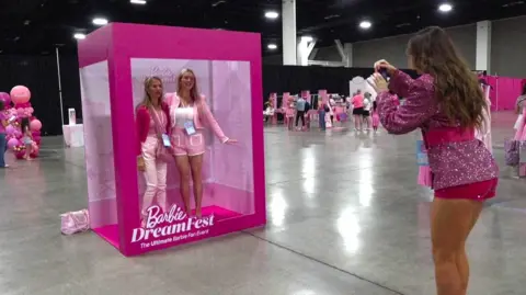 Associated Press Barbie Dream Fest attendees take a photo 