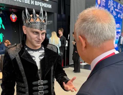 BBC's Steve Rosenberg interviews man dressed as Russian folklore villain "Koshchei the Deathless" at the economic forum