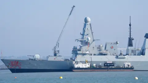 PA Media Royal Navy Type 45 destroyer HMS Dragon at the Upper Harbour Ammunition Facility (UHAF) in Portsmouth harbour