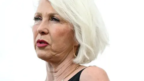 The Denver Post via Getty Images close-up of Peters, who has short white hair and is wearing red lipstick