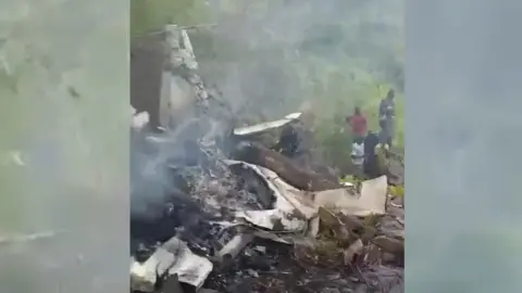 Supplied A blurry picture of a burnt-out rear of a crashed aeroplane.