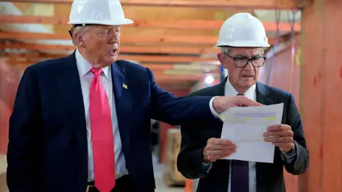 Getty Images Donald Trump appears alongside Jerome Powell on a visit to the Federal Reserve building renovation.