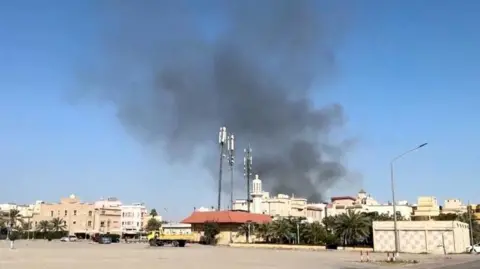 Reuters Smoke rising from building in Bayan, Kuwait