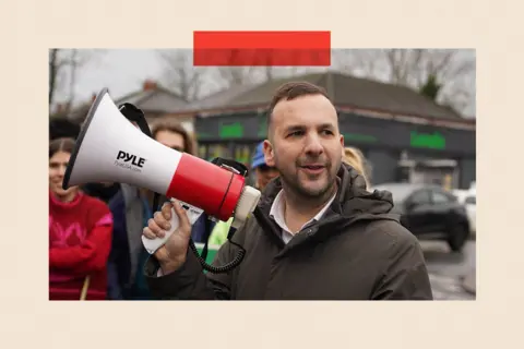 Anadolu via Getty Images Green Party leader Zack Polanski with a megaphone 