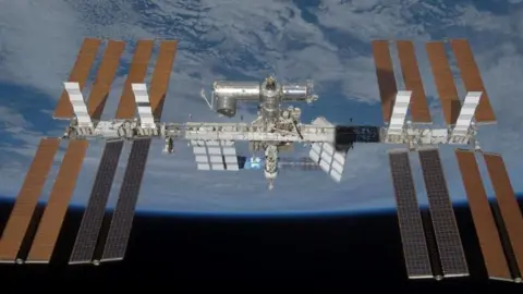 Reuters The International Space Station is seen in the centre of the image in space orbiting the Earth