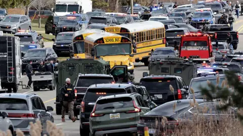 Getty Images Cars and school buses at the synagogue while police respond to the shooting