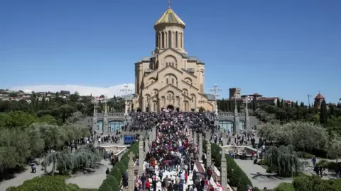 Reuters People approach the Holy Trinity Cathedral during a procession, which was organized by the Patriarchate of Georgia's Orthodox Church to mark the Day of Family Purity and Respect for Parents, in Tbilisi, Georgia,