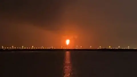 AFP via Getty Images An explosion in Qatar's Ras Laffan industrial zone lighting up the night sky orange