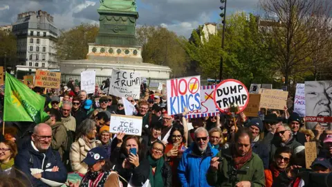 Getty Images A group of protestors hold signs in Paris