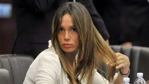 Reuters Nicole Minetti looks at the camera while touching her hair. 