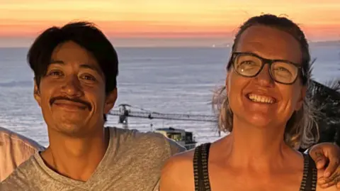 Submitted by Raegan Klein Alfredo and Raegan pose in front of the ocean at sunset