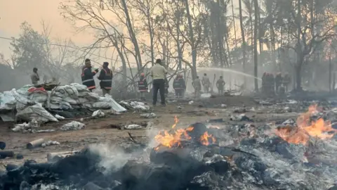 Santosh Kaviyoor Fire department officials douse the flames at the blast site in Kerala on 21 April 2026