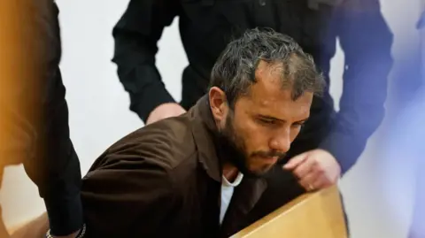 Reuters Thiago Ávila, who has short greying hair and a beard appears in court in Israel.