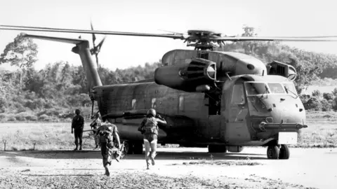 Getty Images US Pararescue team running to a helicopter in Cambodia in 1975. 