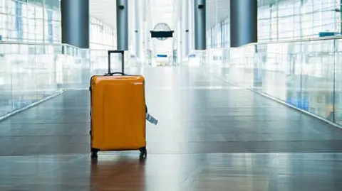 Getty Images A small, yellow carry-on suitcase 