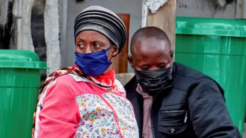 Reuters A woman and a man - both wearing face masks - mourn the death of an Ebola victim in Bunia, in the eastern Democratic Republic of Congo. Photo: 21 May 2026