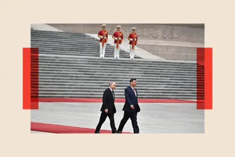 Getty Vladimir Putin and Xi Jinping walk on a red carpet 