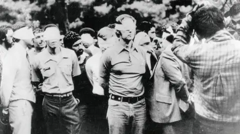 Bettmann via Getty Images American hostages being paraded by their militant Iranian captors after the US embassy was occupied