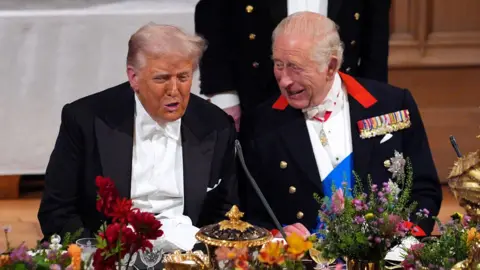 Yui Mok / PA Archive President Trump and King Charles laugh and talk sitting at the table at the banquet while the president was on a trip to the UK in September.